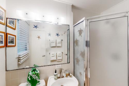 a bathroom with a sink and a shower at Kapa'a Sands 24 in Kapaa