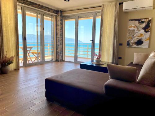 a living room with a couch and a view of the ocean at EKA Luxury Seaview Apartments in Vlorë