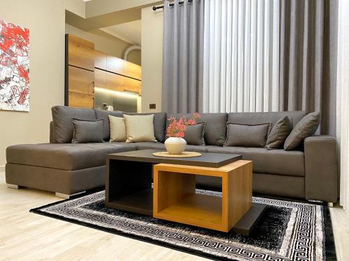 a living room with a couch and a coffee table at EKA Luxury Seaview Apartments in Vlorë