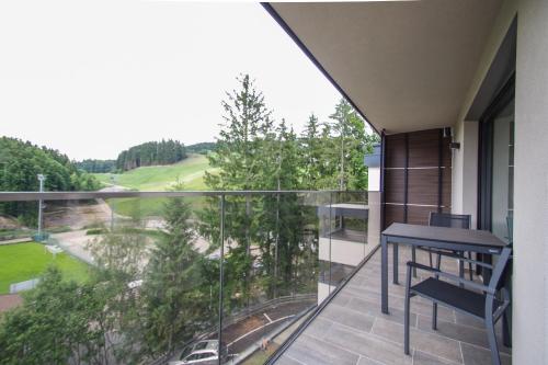 a balcony with a table and chairs and a view at Apartment Hotel Christine in Avelengo