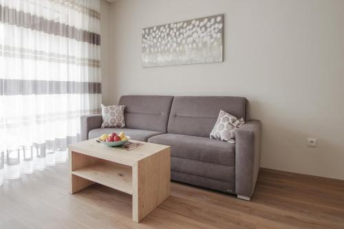 a living room with a couch and a table at Apartment Hotel Christine in Avelengo