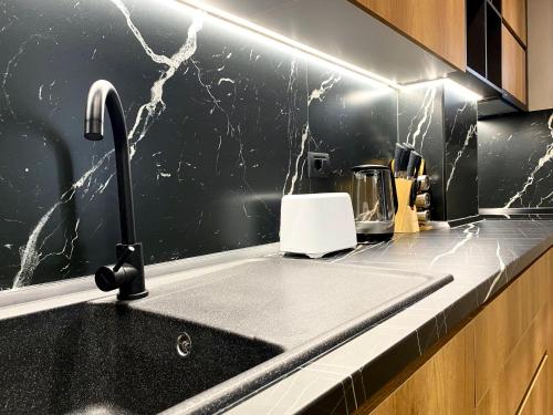 a kitchen with a sink and a counter top at EKA Luxury Seaview Apartments in Vlorë