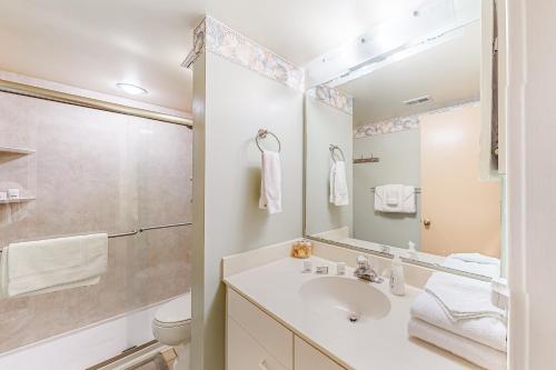 a bathroom with a sink and a toilet and a mirror at Kingston Plantation 6-A in Myrtle Beach