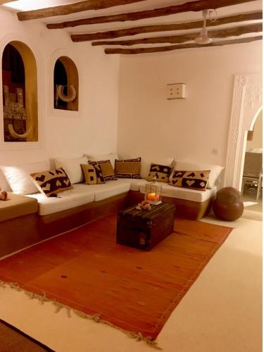 a living room with a couch and a table at White bay pianoB in Watamu