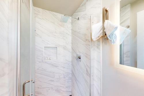 a bathroom with a shower with white marble at Beach 5 Villas #B2 in Fernandina Beach