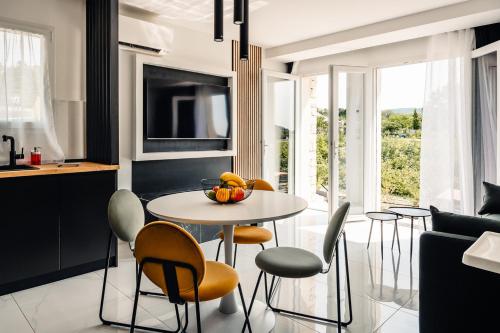a kitchen and dining room with a table and chairs at ANNA : vue sur les vignes, spa exterieur, sans vis-a-vis in Goudargues