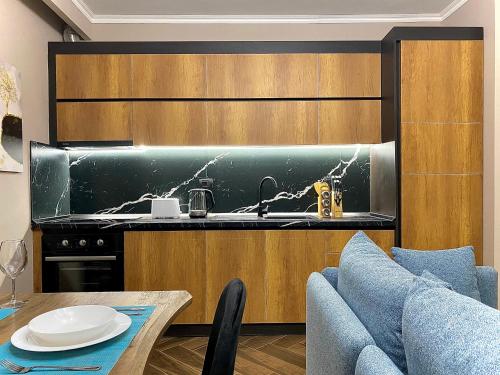 a kitchen with a sink and a table at EKA Luxury Seaview Apartments in Vlorë