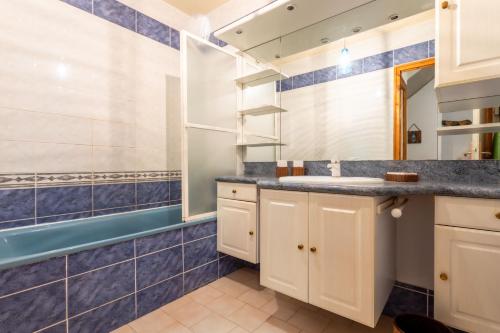 a bathroom with a sink and a mirror at Chalet Laura in Saint-Marcel