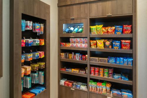 a pantry with shelves filled with chips and snacks at Residence Inn by Marriott Shreveport-Bossier City/Downtown in Bossier City