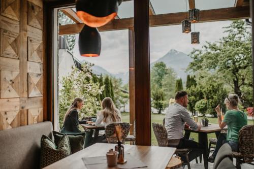 a group of people sitting at tables in a restaurant at Landhotel Laudersbach in Altenmarkt im Pongau