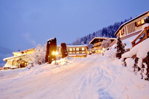 a ski lodge in the snow at night at Landhotel Laudersbach in Altenmarkt im Pongau