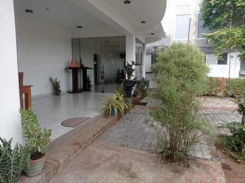 an empty lobby with plants in a building at Senanayaka Holiday Inn in Polonnaruwa
