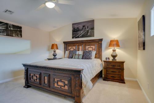a bedroom with a large wooden bed and two lamps at Mesquite Condo with Pool and Spa Access, Near Casinos! in Mesquite