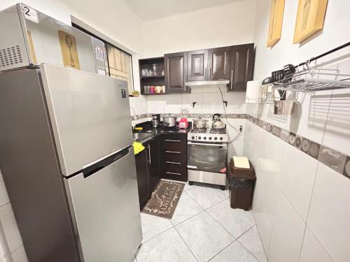 a kitchen with a refrigerator and a stove at Colonial Style Apartment in San Isidro in Lima