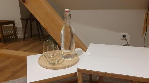 uma garrafa e dois copos sentados numa mesa em La Maison d'Enfance em Heimsbrunn