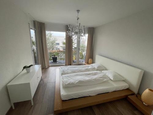a bedroom with a bed and a desk and a window at goodstay in Winterthur