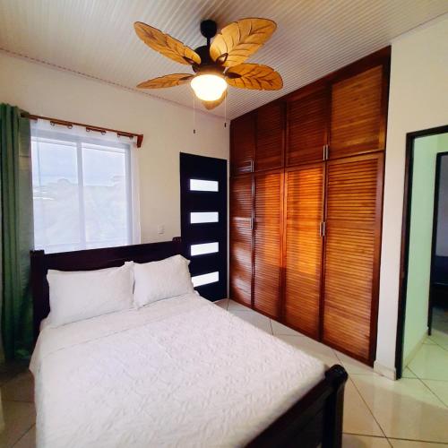 - une chambre avec un lit et un ventilateur de plafond dans l'établissement Quinta El Molino, à San José