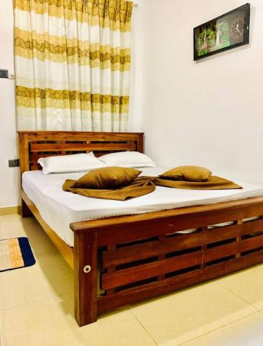 a bed with two pillows on it in a room at Transit house in Katunayaka