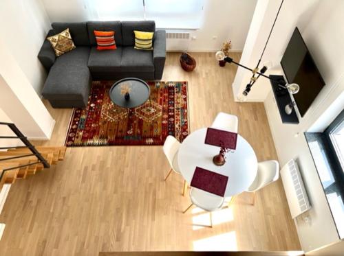 an overhead view of a living room with a couch and a table at Apartman Bjelasnica - vila Smuk in Bjelašnica