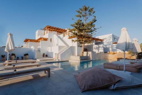 a villa with a swimming pool and a resort at Oliving Mykonos Luxury Suites in Klouvas