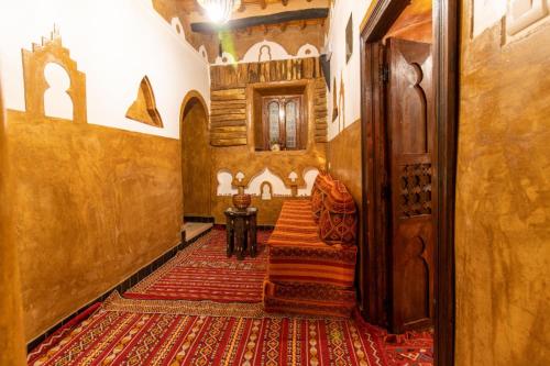 a hallway with a staircase in a building with a rug at Kasbah Assafar in Kalaat MGouna