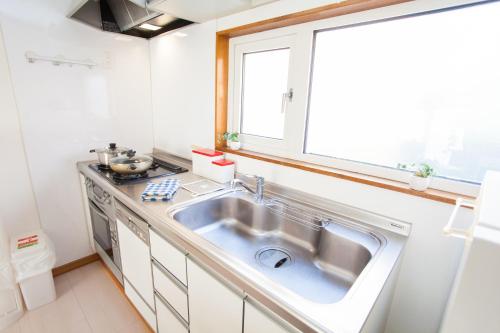 a kitchen with a sink and a window at Yume House in Niseko