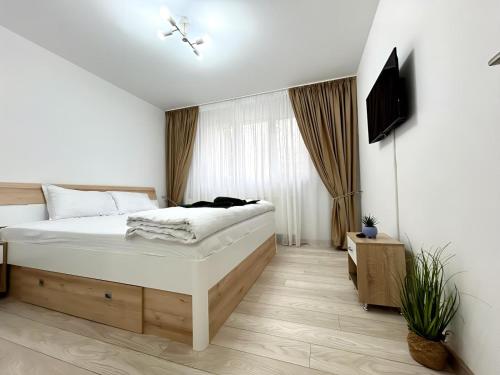Un pat sau paturi într-o cameră la RRR Apartament's