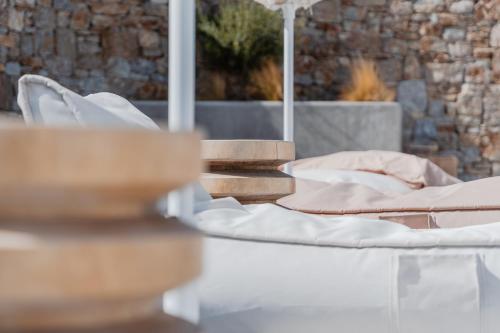 a table with two beds on top at Oliving Mykonos Luxury Suites in Klouvas