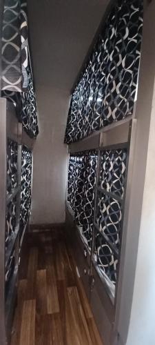 a wine cellar with black and white wine bottles at New Passenger Dormitory in Mumbai