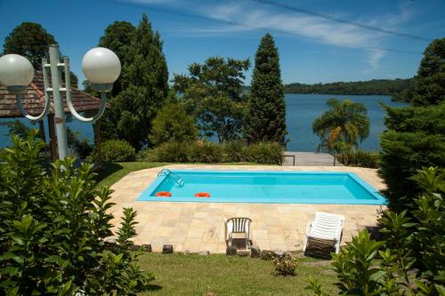 a swimming pool with a view of the water at Laggus Residencial Náutico in Ferraria