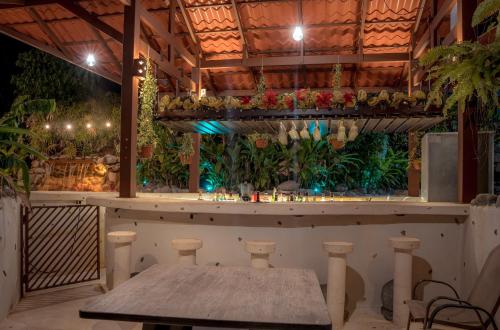a bar with a table in a room with plants at Miradas Arenal Hotel & Hotsprings in Fortuna