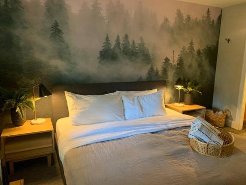 a bedroom with a bed with a painting on the wall at The Eden Whistler - Luxury 2 BDRM Ski in / Ski out in Whistler