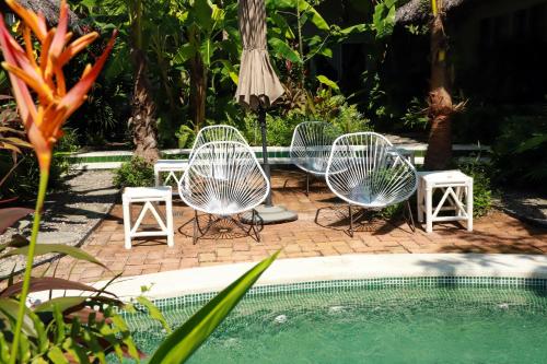 a group of chairs sitting next to a swimming pool at Marii Hotel Boutique in San Francisco