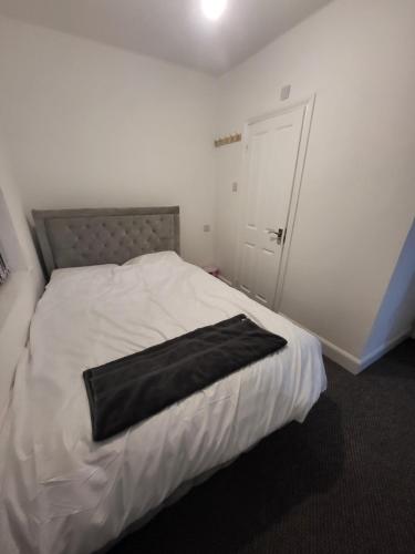 a bedroom with a bed with a black bag on it at Hutton Lodge in Middlesbrough
