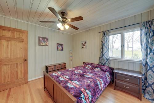 a bedroom with a bed and a ceiling fan at Cozy Lisle Home with Fenced Backyard Pets Welcome! in Lisle