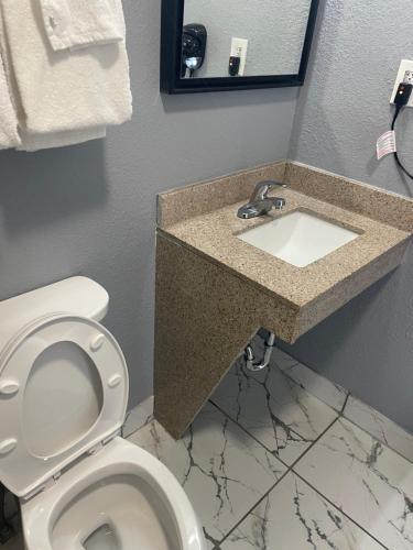 a bathroom with a toilet and a sink at Americas Best Value Inn-Savannah in Savannah