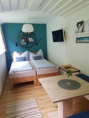 a small room with two beds and a table at Gästehaus Grogger in Weyer Markt