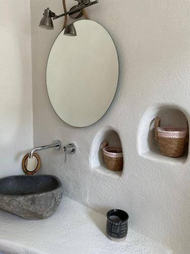 a bathroom with two sinks and a mirror on the wall at Villa Xanthos in Plaka
