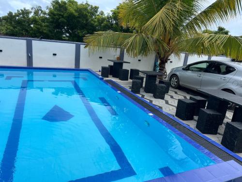 a blue swimming pool with a car parked next to it at Blue Diamond Resort in Trincomalee