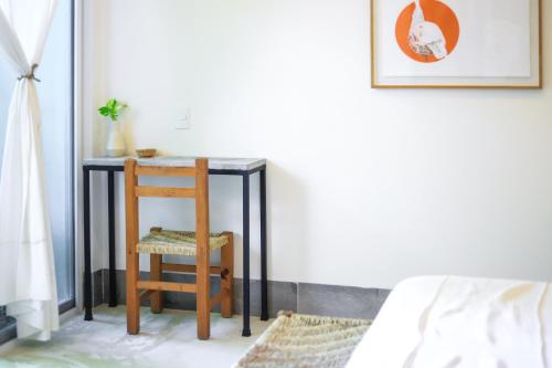 a small table with a chair next to a bed at Marii Hotel Boutique in San Francisco