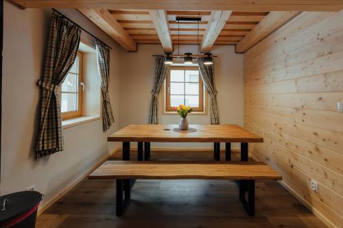 a dining room with a wooden table and a window at Chata pod Mníchom in Terchová