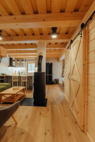 an open living room with a barn door at Chata pod Mníchom in Terchová