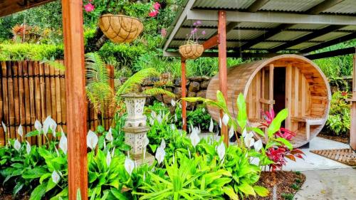 a garden with a bird house and plants at Healing Garden Bed & Breakfast - Ubud in Gold Coast