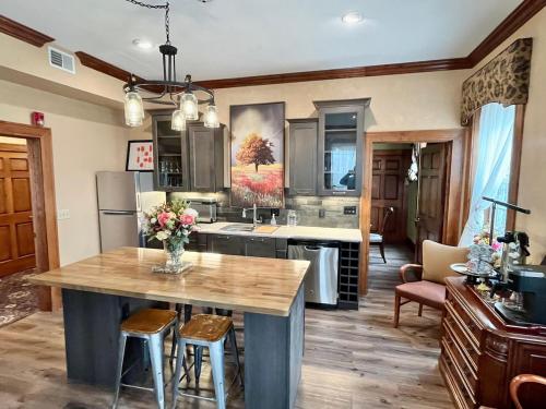 a kitchen with a large wooden table in a room at The Port Hotel in Port Washington