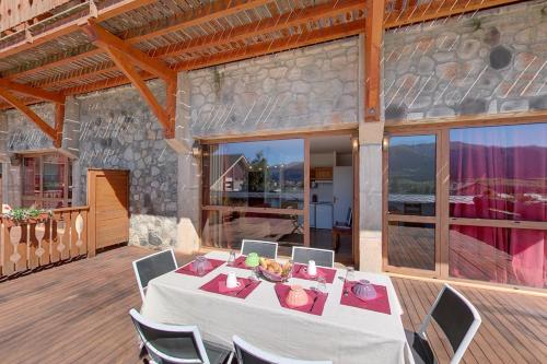 a dining table on a deck in a house at La Pradella in Bolquere Pyrenees 2000
