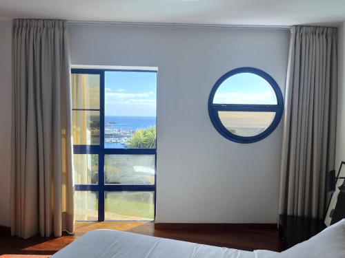 a bedroom with a large window with a view of the ocean at Villa Ramimedi - Vistas al Mar in Puerto del Carmen