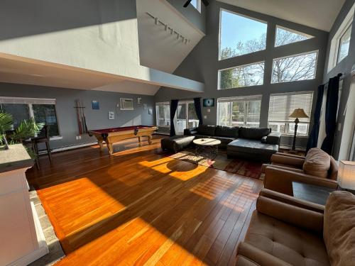 a living room with a couch and a table at Spectacular home with a amazing ocean - river view in Groton