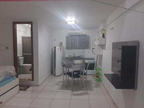 a small kitchen with a table and chairs in it at Flat Amarração 130 in Luis Correia