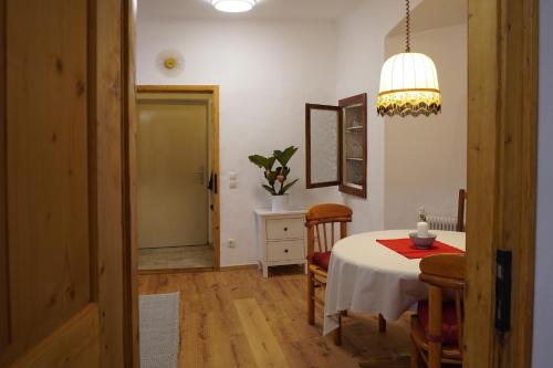 a dining room with a table and chairs and a lamp at Altstadt Apartment am Schergentor in Hall in Tirol