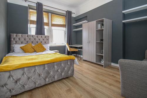 a bedroom with a large bed and a desk at Finnieston Apartment in Glasgow